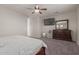 Bedroom showcases a dresser, ceiling fan, and a TV mounted on the wall at 502 E Kona Dr, Casa Grande, AZ 85122