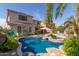 Backyard pool with rock features, palm trees, patio furniture, and attached spa at 502 E Kona Dr, Casa Grande, AZ 85122