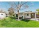 Manicured backyard with lush grass, a covered patio, and mature landscaping, creating an outdoor haven at 520 W Townley Ave, Phoenix, AZ 85021