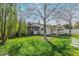 Lush backyard featuring green grass, mature trees, and a covered patio for outdoor enjoyment at 520 W Townley Ave, Phoenix, AZ 85021