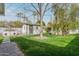 Landscaped backyard with vibrant grass, a storage shed, and an outdoor brick oven at 520 W Townley Ave, Phoenix, AZ 85021