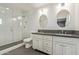 Modern bathroom with dual sinks, sleek vanity, and walk-in shower with glass enclosure at 520 W Townley Ave, Phoenix, AZ 85021