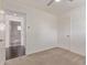 Bright bedroom with modern ceiling fan and a view of a tiled shower in an ensuite bathroom at 520 W Townley Ave, Phoenix, AZ 85021