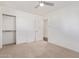 A clean bedroom featuring neutral carpet, white walls and trim, with an open closet at 520 W Townley Ave, Phoenix, AZ 85021