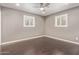 Bedroom showcasing hardwood floors, modern ceiling fan, and window with shutter-style blinds at 520 W Townley Ave, Phoenix, AZ 85021
