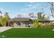 Charming single-story home featuring a well-maintained lawn, desert landscaping, and a convenient carport at 520 W Townley Ave, Phoenix, AZ 85021