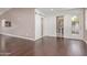 Spacious living room featuring hardwood floors, access to a bathroom, and a sliding barn door at 520 W Townley Ave, Phoenix, AZ 85021