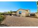 A desert landscaped backyard showcases a covered patio with dining set and a spacious gravel area at 5742 S Winchester St, Mesa, AZ 85212