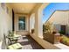 Relaxing front porch with comfortable seating and potted plants, framed by elegant archways and columns at 5742 S Winchester St, Mesa, AZ 85212