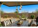 Comfortable outdoor dining area under a striped pergola, complemented by desert landscaping at 5742 S Winchester St, Mesa, AZ 85212