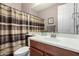 Bathroom with a single vanity, decorative mirror, and shower with striped curtain at 631 W Stanley Ave, San Tan Valley, AZ 85140