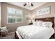 Bedroom features a cozy bed with decorative pillows, side tables, and a ceiling fan at 631 W Stanley Ave, San Tan Valley, AZ 85140