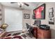 Bedroom features a built in desk, ceiling fan, and large closet with white doors at 631 W Stanley Ave, San Tan Valley, AZ 85140