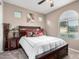 Bedroom features a cozy bed with decorative pillows, side tables, and a ceiling fan at 631 W Stanley Ave, San Tan Valley, AZ 85140