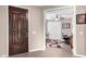 Inviting foyer with a rich wood door, neutral walls, and view to adjacent office space at 631 W Stanley Ave, San Tan Valley, AZ 85140