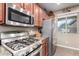 Kitchen with stainless steel appliances, granite counters, wood cabinets and tile floor at 631 W Stanley Ave, San Tan Valley, AZ 85140
