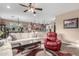 Comfortable living room with a plush sofa, red leather recliner, and an open view to the dining area and kitchen at 631 W Stanley Ave, San Tan Valley, AZ 85140