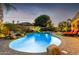 Backyard swimming pool with waterfall feature and manicured landscaping at 631 W Stanley Ave, San Tan Valley, AZ 85140
