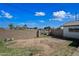 An empty backyard space with a block fence, offering a secure and private outdoor area at 7102 W Wilshire Dr, Phoenix, AZ 85035