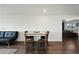 A dining area with seating for four, plus a leather couch next to the dining area at 7102 W Wilshire Dr, Phoenix, AZ 85035
