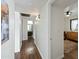 Hallway with wood floors that leads to a bedroom and bathroom at 7102 W Wilshire Dr, Phoenix, AZ 85035