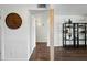 Hallway features white walls and trim with wood-look flooring throughout and a vintage clock at 7102 W Wilshire Dr, Phoenix, AZ 85035