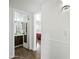 Hallway with views into the bathroom and bedroom with neutral paint and wood-look floors at 7102 W Wilshire Dr, Phoenix, AZ 85035