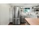 Kitchen featuring stainless steel refrigerator and dishwasher, butcher block countertops, and gray cabinets at 7102 W Wilshire Dr, Phoenix, AZ 85035