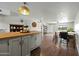 Open-concept kitchen and dining area with modern lighting and wood-style flooring throughout at 7102 W Wilshire Dr, Phoenix, AZ 85035