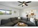 Bright living room featuring a large sectional sofa, and views into the kitchen at 7102 W Wilshire Dr, Phoenix, AZ 85035