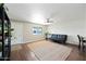 Comfortable living room with ample light, neutral decor and wood-look floors at 7102 W Wilshire Dr, Phoenix, AZ 85035