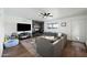 Comfortable living room with a brick fireplace, large sectional sofa, and hardwood floors at 7102 W Wilshire Dr, Phoenix, AZ 85035
