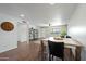 An open living space features wood-look floors, a dining area and a view of the front yard at 7102 W Wilshire Dr, Phoenix, AZ 85035