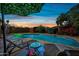 Relaxing pool view at sunset with lounge chairs and lush surroundings at 7102 W Wilshire Dr, Phoenix, AZ 85035