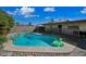 Outdoor pool with pool toys, lounge chairs, and covered patio area at 7102 W Wilshire Dr, Phoenix, AZ 85035