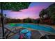 Backyard pool with lounge chairs, shade and lush landscaping provides a relaxing outdoor retreat at 7102 W Wilshire Dr, Phoenix, AZ 85035