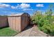 The backyard shed offers extra outdoor storage with landscaping and a beautiful blue sky at 7102 W Wilshire Dr, Phoenix, AZ 85035