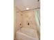 Bathroom with a soaking tub and tiled walls at 7121 E Rancho Vista Dr # 1008, Scottsdale, AZ 85251