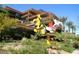 Beautiful apartment building with unique sculpture and lush landscaping, creating an inviting outdoor space at 7121 E Rancho Vista Dr # 1008, Scottsdale, AZ 85251