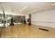 Spacious fitness room with mirrored wall, wood floors, punching bag, and windows providing natural light at 7121 E Rancho Vista Dr # 1008, Scottsdale, AZ 85251