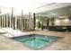 Inviting indoor hot tub with tiled edges and walls, and large glass windows overlooking the exterior, perfect for relaxation at 7121 E Rancho Vista Dr # 1008, Scottsdale, AZ 85251
