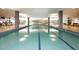 Well-lit indoor pool area with clear water, marked lanes, and large windows, perfect for year-round enjoyment at 7121 E Rancho Vista Dr # 1008, Scottsdale, AZ 85251