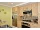 Modern kitchen with stainless steel appliances and light wood cabinetry at 7121 E Rancho Vista Dr # 1008, Scottsdale, AZ 85251