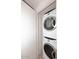 Efficient laundry area features a stacked washer and dryer, maximizing space and convenience at 7121 E Rancho Vista Dr # 1008, Scottsdale, AZ 85251