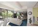 Bright living room with floor-to-ceiling windows offering views of the lush exterior at 7121 E Rancho Vista Dr # 1008, Scottsdale, AZ 85251