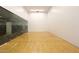 Indoor racquetball court featuring hardwood floors, white walls, a glass back wall, and clear court lines at 7121 E Rancho Vista Dr # 1008, Scottsdale, AZ 85251