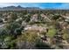 Expansive property featuring lush landscaping, mature trees, and a beautiful tile roof, set against a mountain backdrop at 8325 N 73Rd Pl, Scottsdale, AZ 85258