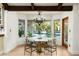 Dining room with views of the backyard pool area and manicured landscaping at 8325 N 73Rd Pl, Scottsdale, AZ 85258