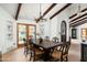Dining room featuring wood floors, exposed beams, and a stylish chandelier at 8325 N 73Rd Pl, Scottsdale, AZ 85258