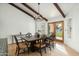 Dining room featuring wood floors, exposed beams, and a stylish chandelier at 8325 N 73Rd Pl, Scottsdale, AZ 85258